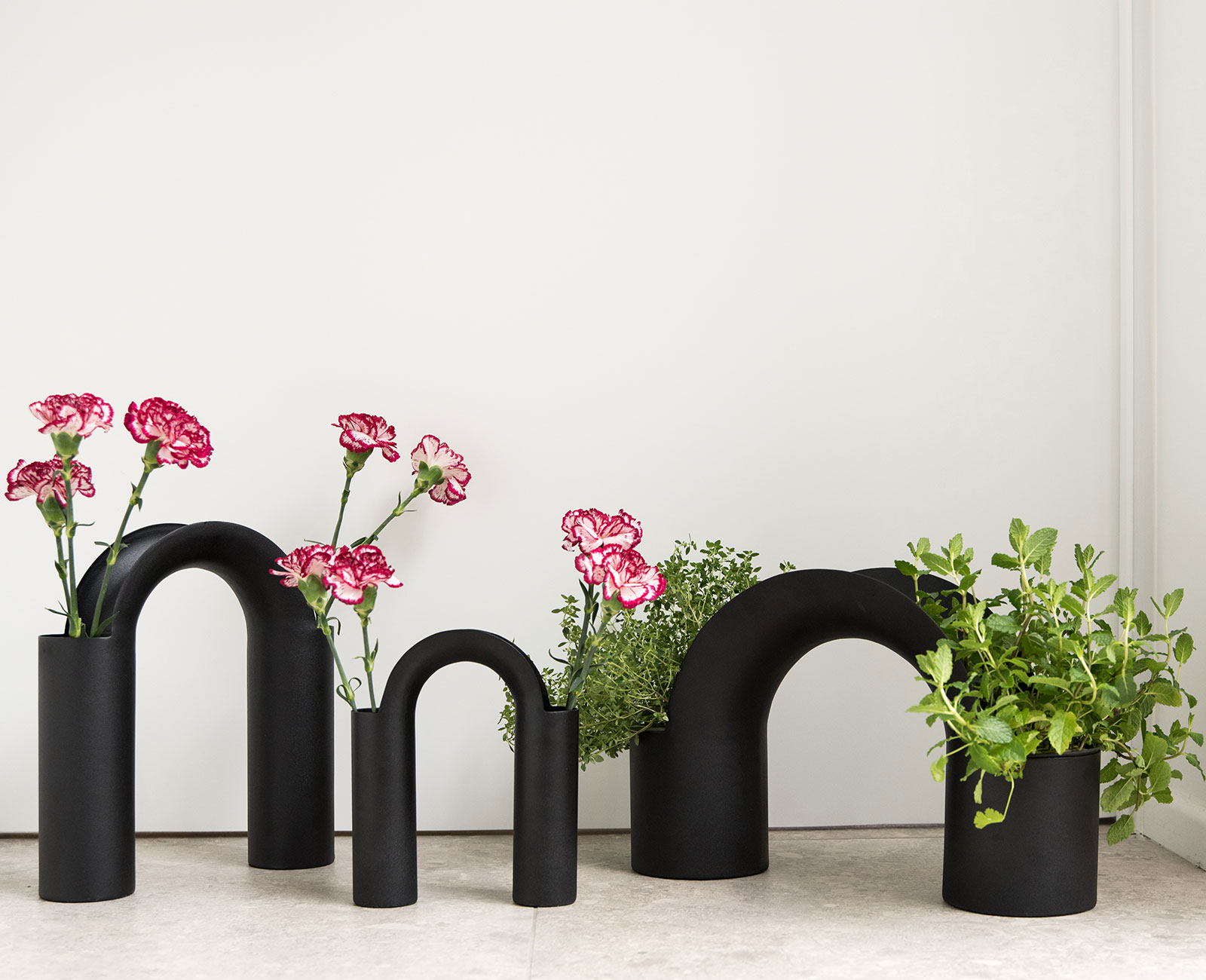 Bridge vase collection with flowers and grass