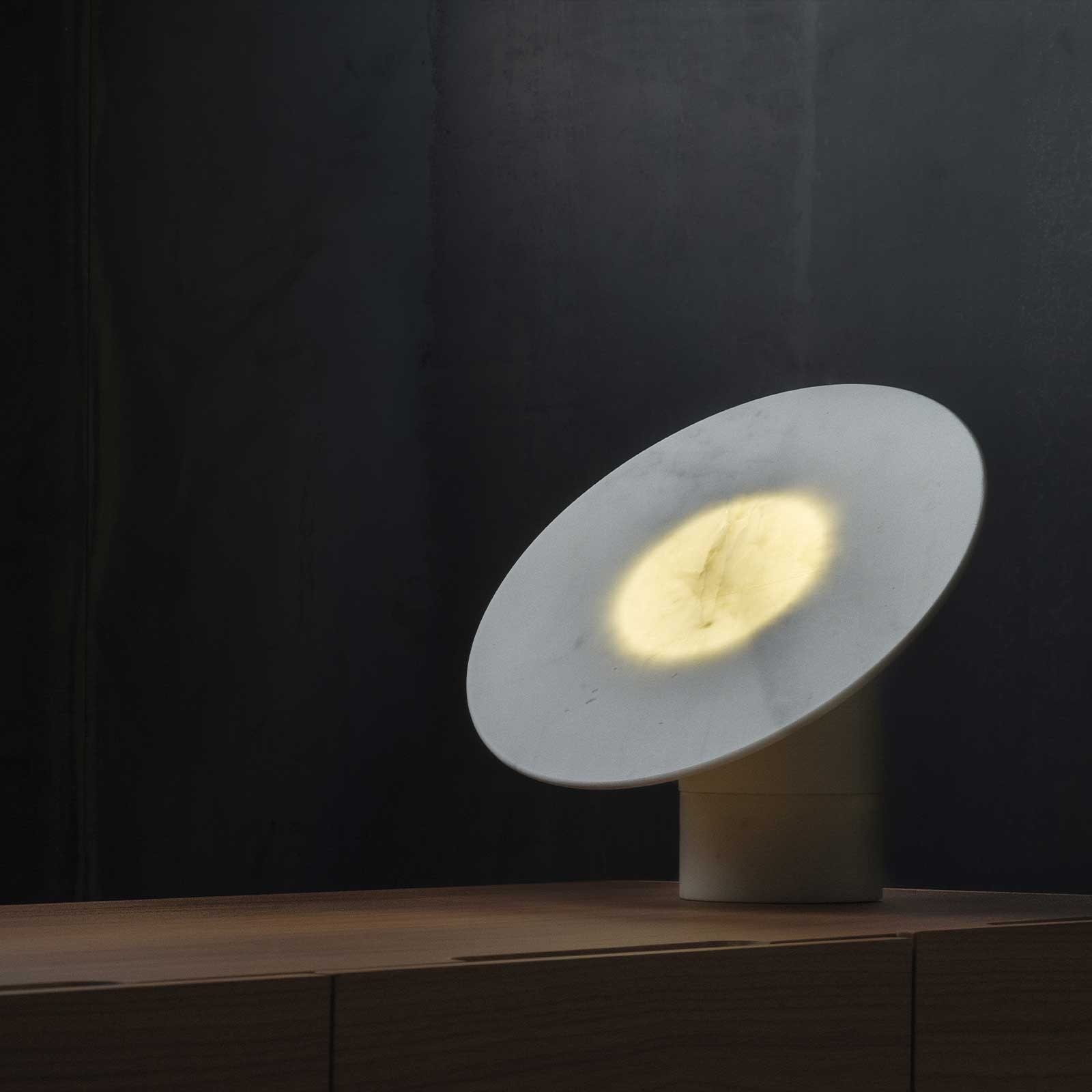 Aura object on a wooden sideboard, warm center visible